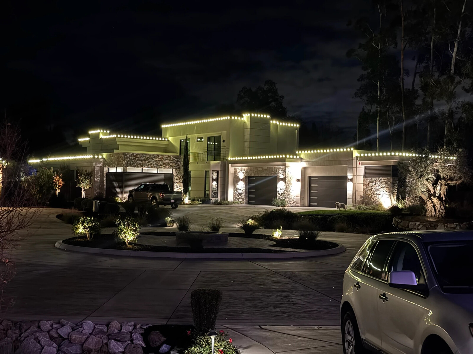 Christmas light hanging in Carmichael, CA: modern estate warm white parapet roofline