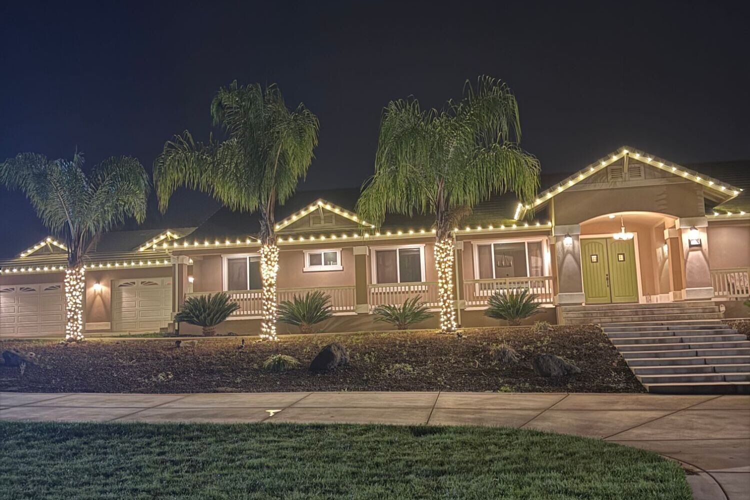 Christmas lights in Folsom, CA: ranch home warm white roofline palm wraps front